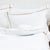 白いリネンにベージュのクロスコードの縁飾り刺繍で色を添えたピローケース | Beaumont & Brown